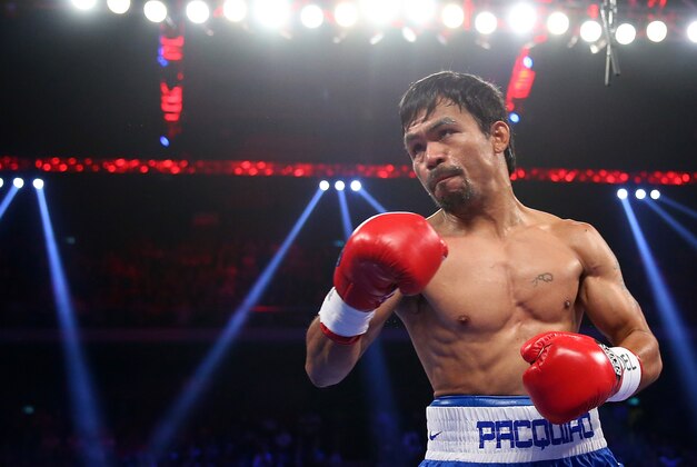 MACAU - NOVEMBER 23:  Manny Pacquiao of the Philippines punches Chris Algieri of the United States during the WBO world welterweight title at The Venetian on November 23, 2014 in Macau, Macau.  (Photo by Chris Hyde/Getty Images)