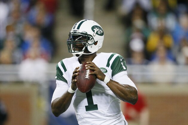 New York Jets quarterback Michael Vick looks downfield during the first half of an NFL football game against the Buffalo Bills in Detroit, Monday, Nov.24, 2014. (AP Photo/Rick Osentoski)