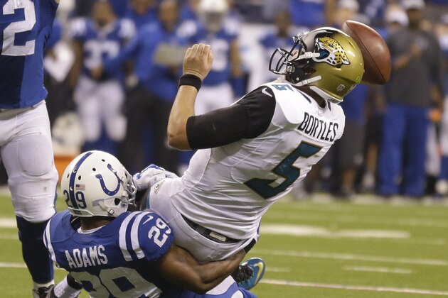 Jacksonville Jaguars quarterback Blake Bortles (5) throws as he is tackled by Indianapolis Colts strong safety Mike Adams (29) during the second half of an NFL football game Sunday, Nov. 23, 2014 in Indianapolis. (AP Photo/Michael Conroy)