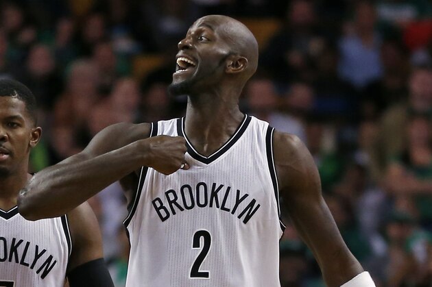 Brooklyn Nets center Kevin Garnett (2) argues as he and teammates, Alan Anderson (6) and Joe Johnson (7) walk down court during a break in the fourth quarter of an NBA basketball game against the Boston Celtics in Boston, Wednesday, Oct. 29, 2014. The Celtics won 121-105. (AP Photo/Elise Amendola)