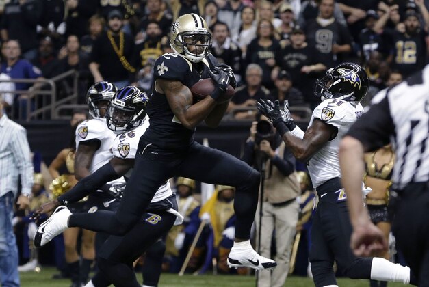 New Orleans Saints wide receiver Marques Colston (12) pulls in a touchdown reception in front of Baltimore Ravens strong safety Matt Elam (26) in the first half of an NFL football game in New Orleans, Monday, Nov. 24, 2014. (AP Photo/Jonathan Bachman)