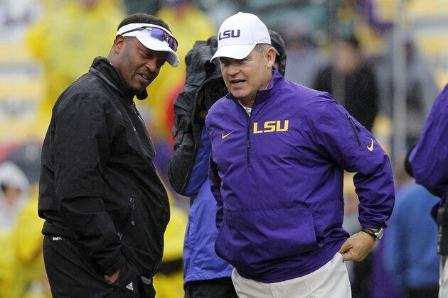 LSU head coach Les Miles, right, talks with Texas A&M head coach Kevin Sumlin before an NCAA college football game in Baton Rouge, La., Saturday, Nov. 23, 2013. (AP Photo/Gerald Herbert)