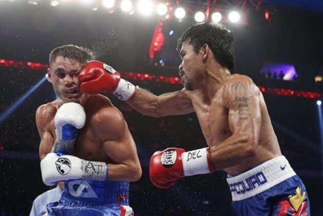 WBO welterweight champion Manny Pacquiao, right, of the Philippines lands a right on the face of WBO junior welterweight champion Chris Algieri of the United States during their welterweight boxing title fight at the Venetian Macao in Macau, Sunday, Nov. 23, 2014. (AP Photo/Kin Cheung)