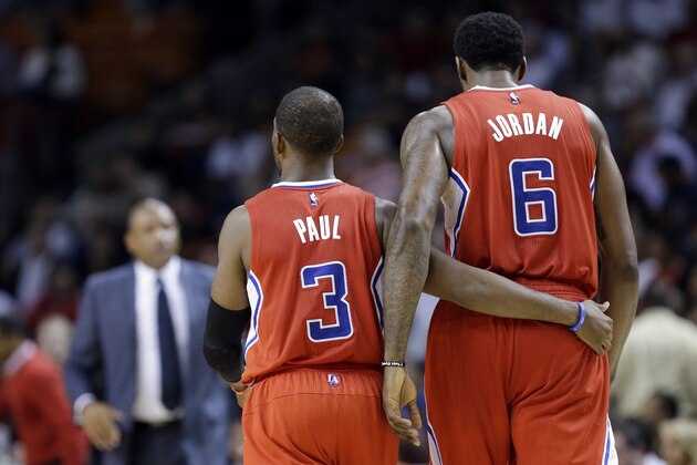 Los Angeles Clippers guard Chris Paul (3) puts his arm around center DeAndre Jordan (6) in the second half of an NBA basketball game against the Miami Heat, Thursday, Nov. 20, 2014, in Miami. The Clippers defeated the Heat 110-93. (AP Photo/Lynne Sladky)