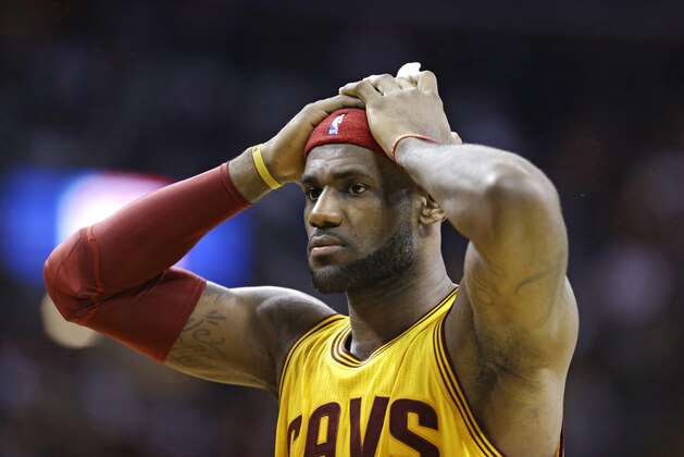 Cleveland Cavaliers' LeBron James reacts when he does not get a foul called against the San Antonio Spurs during an NBA basketball game Wednesday, Nov. 19, 2014, in Cleveland. (AP Photo/Tony Dejak)