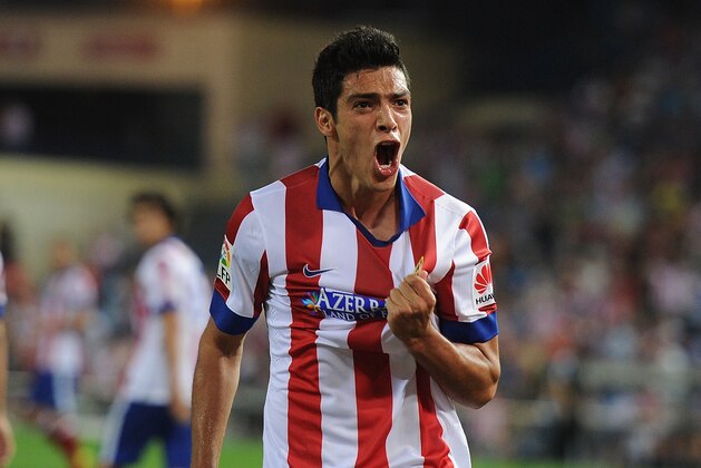 MADRID, SPAIN - SEPTEMBER 20:  Raul Jimenez of Club Atletico de Madrid celebrates after beating Sergio Alvarez of Real Club Celta de Vigo to put the ball in the net during the La Liga match at the Vicente Calderon stadium on September 20, 2014 in Madrid, Spain.  The goal was disallowed.  (Photo by Denis Doyle/Getty Images)