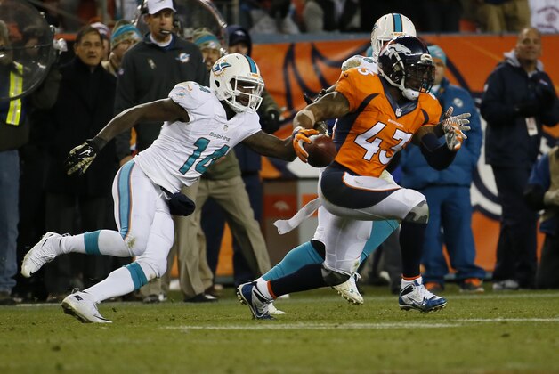 Denver Broncos strong safety T.J. Ward (43) runs after making an interception against the Miami Dolphins during the second half of an NFL football game, Sunday, Nov. 23, 2014, in Denver. (AP Photo/Jack Dempsey)
