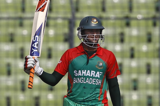 Bangladesh's Shakib Al Hasan acknowledges the crowd after scoring fifty runs during their first one-day International cricket match against India in Dhaka, Bangladesh, Sunday, June 15, 2014. (AP Photo/A.M. Ahad)