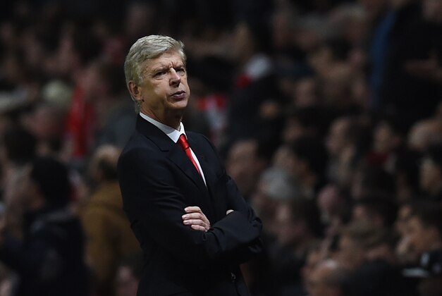 Arsenal’s manager Arsene Wenger looks across the pitch during the English Premier League soccer match between Arsenal and Manchester United at the Emirates Stadium, London, Saturday, Nov. 22, 2014. (AP Photo/Tim Ireland)