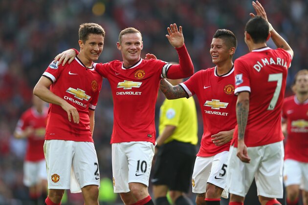 MANCHESTER, ENGLAND - SEPTEMBER 14:  Wayne Rooney of Manchester United celebrates scoring the third goal with team-mates Ander Herrera (L), Marcos Rojo and Angel Di Maria during the Barclays Premier League match between Manchester United and Queens Park Rangers at Old Trafford on September 14, 2014 in Manchester, England.  (Photo by Alex Livesey/Getty Images)