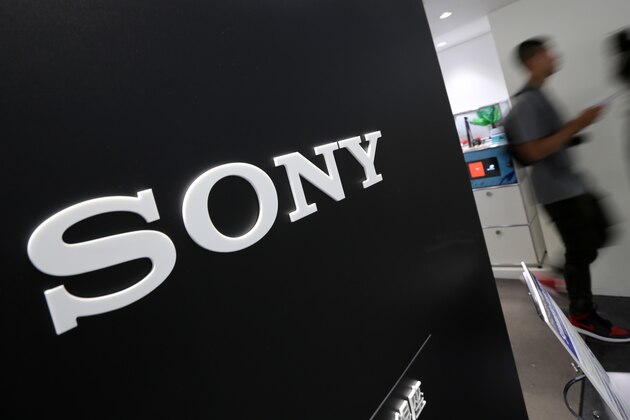 Visitors walk past a logo of Sony at Sony Building in Tokyo Thursday, July 31, 2014. Sony reported a surprise eightfold jump in quarterly profit as sales got a perk from a cheap yen and its bottom line was helped by gains from buildings and its stake in a video-game maker. (AP Photo/Eugene Hoshiko)