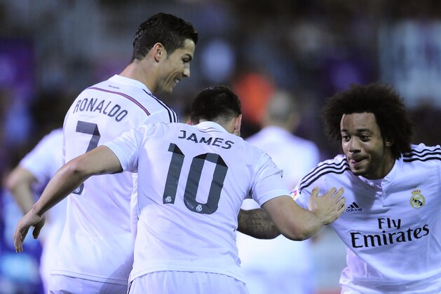 Real Madrid's James Rodriguez of Colombia, center, celebrates his goal with Cristiano Ronaldo of Portugal, left, and Marcelo of Brazil after scoring against SD Eibar, during their La Liga soccer match, at Ipurua stadium in Eibar, northern Spain, Saturday Nov. 22, 2014.  Real Madrid won 4-0. (AP Photo/Alvaro Barrientos)