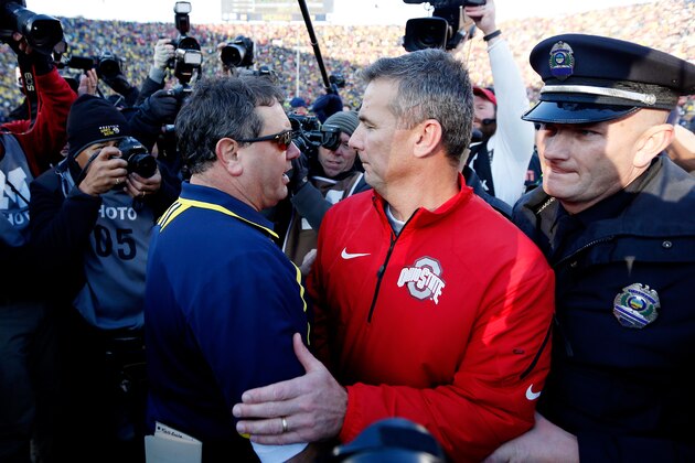 ANN ARBOR, MI - NOVEMBER 30:  Head coach Brady Hoke of the Michigan Wolverines and head coach Urban Meyer of the Ohio State Buckeyes meet on the field after the Ohio State Buckeyes defeated the Michigan Wolverines 42-41 at Michigan Stadium on November 30, 2013 in Ann Arbor, Michigan.  (Photo by Gregory Shamus/Getty Images)