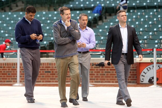 Sep 15, 2014; Chicago, IL, USA; From left Chicago Cubs vice president of player development Jason McLeod , owner Tom Ricketts , general manager Jed Hoyer , and vice president of baseball operations Theo Epstein walk across the field before the game against the Cincinnati Reds at Wrigley Field. Mandatory Credit: Jerry Lai-USA TODAY Sports