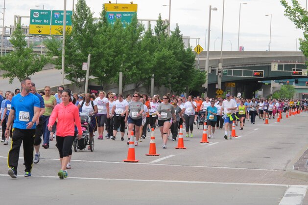 Thousands run and walk in a 5K on Saturday, May 4, 2013,  in front of the Cincinnati Bengals stadium as part of weekend-long events of the Flying Pig Marathon, now in its 15th year. A 5K and 10K on Saturday were sold-out, as were a half and full marathon set for Sunday, with more than 33,000 participants expected overall. (AP Photo/Amanda Lee Myers)