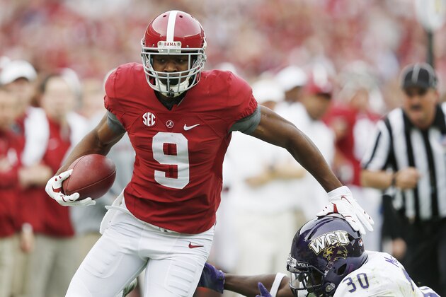Alabama wide receiver Amari Cooper (9) avoids the tackle from Western Carolina defensive back A.J. McKoy (30) during the first half of an NCAA college football game, Saturday, Nov. 22, 2014, in Tuscaloosa, Ala. Cooper limped off the field after an injury on the play. (AP Photo/Brynn Anderson)