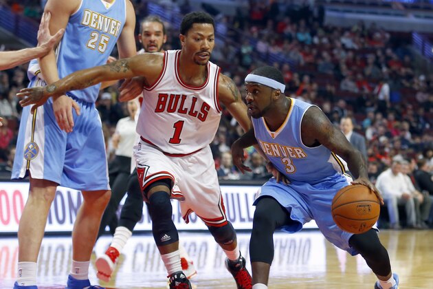 Chicago Bulls guard Derrick Rose (1) guards Denver Nuggets guard Ty Lawson (3) during the first half of a pre-season NBA basketball game in Chicago, on Monday Oct. 13, 2014. (AP Photo/Jeff Haynes)