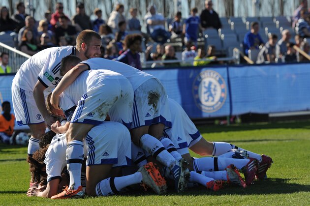 GUILDFORD, ENGLAND - MARCH 16: Maurice Multhaup of FC Schalke 04 celebrates scoring his goal with his teamates during the UEFA Youth League Quarter Final match between Chelsea and FC Schalke 04 at the Chelsea Cobham training ground on March 16, 2014 in Guildford, England.  (Photo by Steve Bardens/Getty Images)
