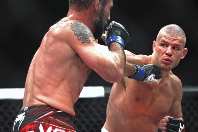 Matt Wiman, right, throws a punch at Isaac Vallie-Flagg in a lightweight mixed martial arts bout during UFC Fight Night in Austin, Texas, Saturday, Nov. 22, 2014. (AP Photo/Michael Thomas)
