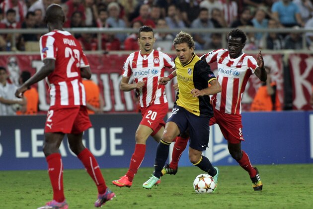 ATHENS, GREECE - SEPTEMBER 16:   Atletico's Alessio Cerci is challenged by Olympiako's Omar Elabdellaoui, for the ball during during the Champions League Group A soccer match between Olympiakos and Atletico Madrid at Georgios Karaiskakis Stadium in  Piraeus near Athens, Tuesday, Sept. 16, 2014.   (Photo by Milos Bicanski/Getty Images)