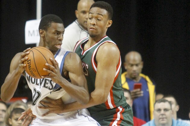 Minnesota Timberwolves forward Andrew Wiggins, left, drives to the basket past Milwaukee Bucks forward Jabari Parker during the first half of a preseason NBA basketball game, Friday, Oct. 17, 2014, in Cedar Rapids, Iowa. (AP Photo/Matthew Holst)