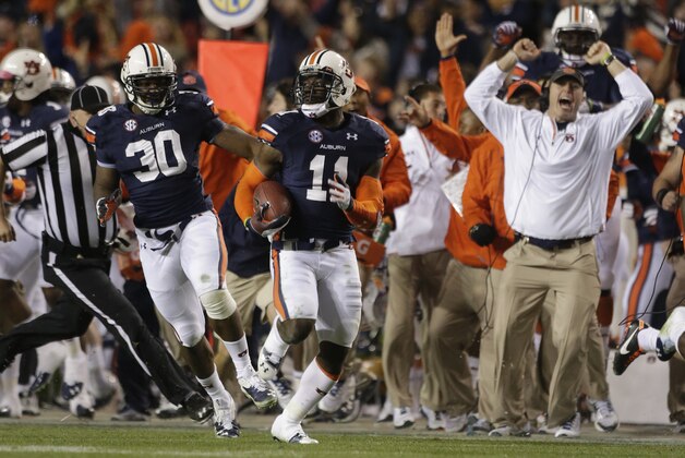 Auburn cornerback Chris Davis (11) returns a missed field goal attempt 100-plus yards to score the game-winning touchdown as time expired in the fourth quarter of an NCAA college football game against No. 1 Alabama in Auburn, Ala., Saturday, Nov. 30, 2013. Auburn won 34-28. (AP Photo/Dave Martin)