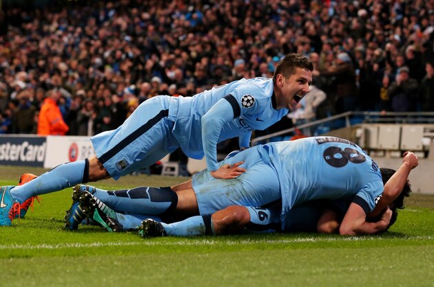 MANCHESTER, ENGLAND - NOVEMBER 25:  Sergio Aguero #16 (on ground) of Manchester City celebrates with teammate Stevan Jovetic (L) and Frank Lampard #18 after scoring his team's third and matchwinning goal during the UEFA Champions League Group E match between Manchester City and FC Bayern Muenchen at the Etihad Stadium on November 25, 2014 in Manchester, United Kingdom.  (Photo by Alex Livesey/Getty Images)