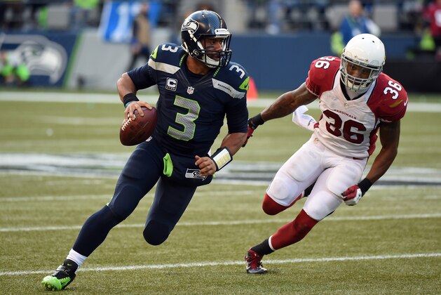 SEATTLE, WA - NOVEMBER 23:  Russell Wilson #3 of the Seattle Seahawks runs the ball out of the pocket in the third quarter against  Deone Bucannon #36 of the Arizona Cardinals during their game at CenturyLink Field on November 23, 2014 in Seattle, Washington.  (Photo by Steve Dykes/Getty Images)