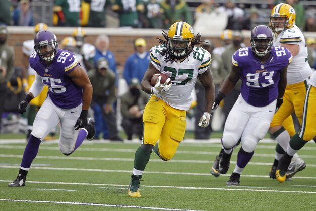 Green Bay Packers running back Eddie Lacy (27) runs from Minnesota Vikings outside linebacker Anthony Barr, left, and defensive tackle Shamar Stephen (93) during the second half of an NFL football game, Sunday, Nov. 23, 2014, in Minneapolis. (AP Photo/Ann Heisenfelt)