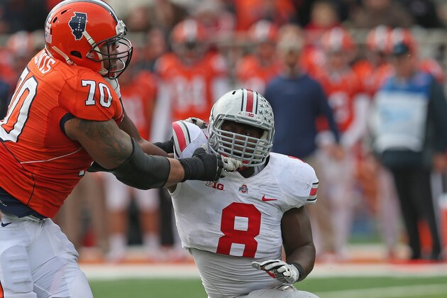 CHAMPAIGN, IL - NOVEMBER 16:  Noah Spence #8 of the Ohio State Buckeyes rushes against Corey lewis #70 of the Illinois Fighting Illini at Memorial Stadium on November 16, 2013 in Champaign, Illinois. Ohio State defeated Illinois 60-35.  (Photo by Jonathan Daniel/Getty Images)