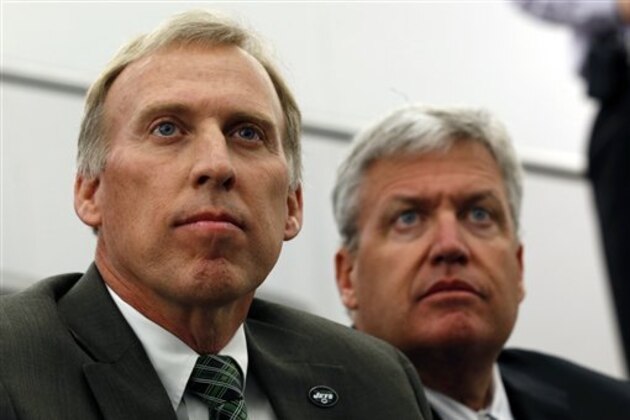 John Idzik, left, sits next to New York Jets head coach Rex Ryan while waiting to be introduced as the Jets new general manager during an NFL football news conference, Thursday, Jan. 24, 2013, in Florham Park , N.J. (AP Photo/Julio Cortez)