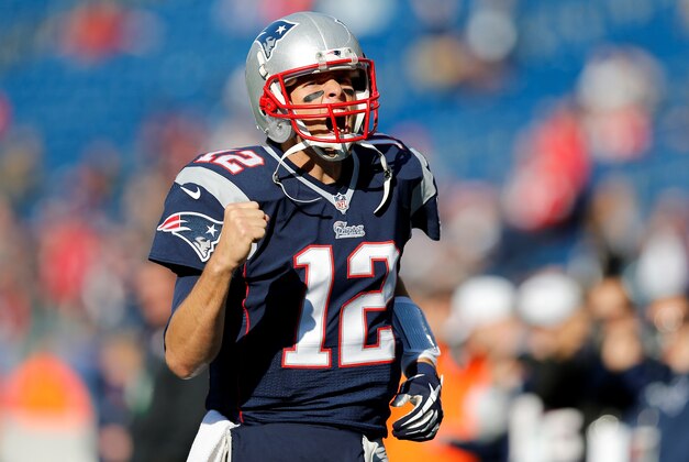 Nov 23, 2014; Foxborough, MA, USA; New England Patriots quarterback Tom Brady (12) pumps his fist as he takes the field before the game against the Detroit Lions at Gillette Stadium. Mandatory Credit: Greg M. Cooper-USA TODAY Sports