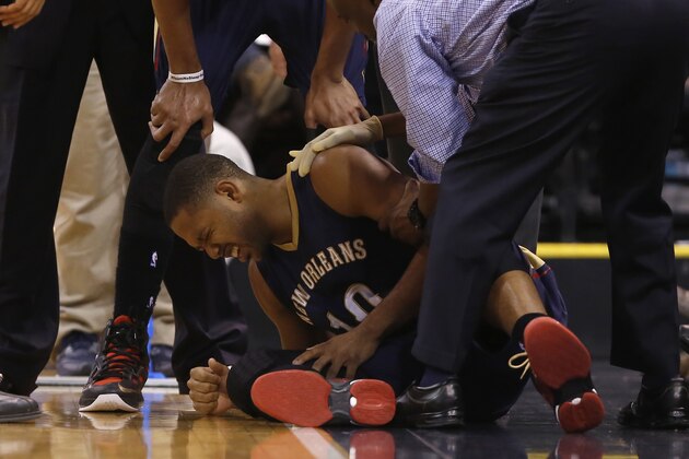 New Orleans Pelicans guard Eric Gordon (10) reacts after being injured during the first half of their NBA Basketball game against the Utah Jazz in Salt Lake City, Utah, Saturday, Nov. 22, 2014. (AP Photo/Jim Urquhart)