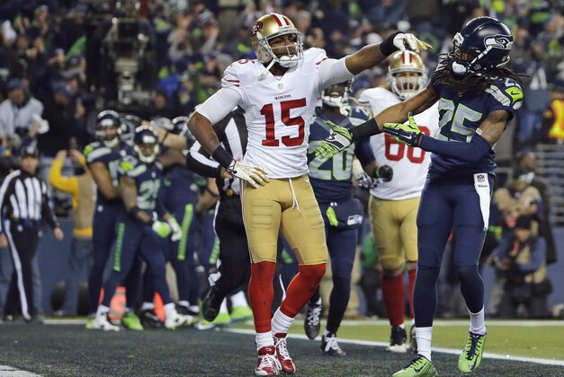 FILE- In this Jan. 19, 2014, file photo, Seattle Seahawks' Richard Sherman (25) reaches out to shake hands with San Francisco 49ers' Michael Crabtree (15) after Sherman tipped a pass in the end zone intended for Crabtree in the final minute of the second half of the NFC championship NFL football game in Seattle. Seattle's Malcolm Smith intercepted the tipped pass. Sherman was fined $7,875 for unsportsmanlike conduct/taunting after he made a choking gesture after the play toward the San Francisco bench after the play that he said was directed at quarterback Colin Kaepernick.  (AP Photo/Matt Slocum, File)