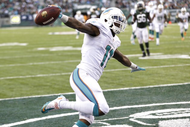 Miami Dolphins wide receiver Mike Wallace celebrates after scoring on a touchdown pass from quarterback Ryan Tannehill during the second half of an NFL football game against the New York Jets, Sunday, Dec. 1, 2013, in East Rutherford, N.J. (AP Photo/Seth Wenig)