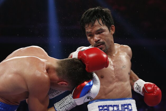 WBO welterweight champion Manny Pacquiao, right, of the Philippines lands a right on the head of WBO junior welterweight champion Chris Algieri of the United States during their world welterweight title boxing match at the Venetian Macao in Macau, Sunday, Nov. 23, 2014. (AP Photo/Kin Cheung)