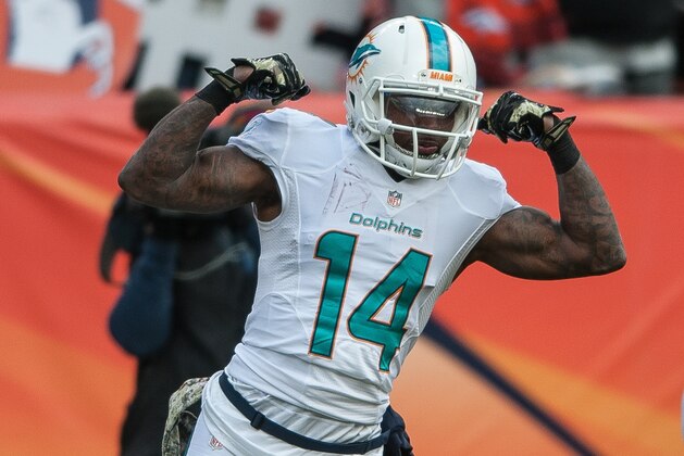 DENVER, CO - NOVEMBER 23:  Wide receiver Jarvis Landry #14 of the Miami Dolphins celebrates a 20-yard reception in the first quarter of a game against the Denver Broncos at Sports Authority Field at Mile High on November 23, 2014 in Denver, Colorado.  (Photo by Dustin Bradford/Getty Images)
