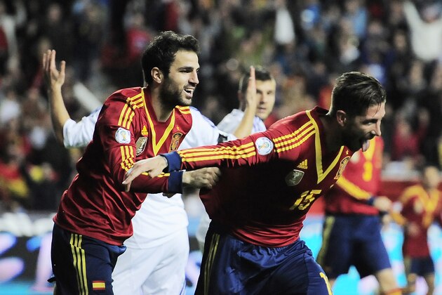 Spain's Sergio Ramos, right, celebrates with fellow teammate Cesc Fabregas after scoring against Finland during a Group I 2014 World Cup qualifying soccer match, at El Molinon stadium in Gijon, northern Spain on Friday, March 22, 2013.  (AP Photo/Alvaro Barrientos)
