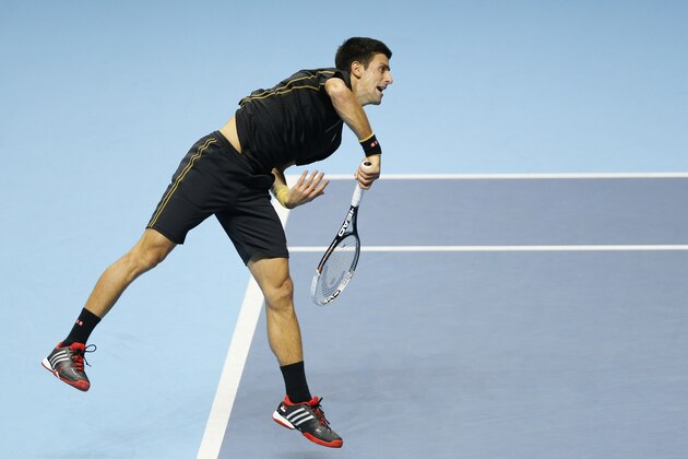 Serbia’s Novak Djokovic serves to Britain’s Andy Murray during an improvised exhibition tennis match at the O2 arena in London, Sunday, Nov. 16, 2014. Serbia’s Novak Djokovic was meant to have played against Switzerland’s Roger Federer in the final of the ATP World Tour tennis final, however Federer withdrew due to injury allowing Djokovic to win the title with a walkover. The Murray against Djokovic match was put on in its place. (AP Photo/Kirsty Wigglesworth)