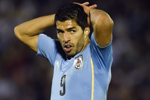 Uruguay's Luis Suarez, stands with his ripped jersey after missing a chance to score during a friendly soccer match against Costa Rica in Montevideo, Uruguay, Thursday, Nov. 13, 2014. (AP Photo/Matilde Campodonico)