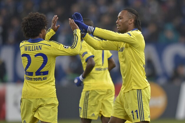 Chelsea's Didier Drogba, right, celebrates his goal with teammate Willian during the Champions League group G soccer match between FC Schalke 04 and Chelsea in Gelsenkirchen, Germany, Tuesday, Nov. 25, 2014. Schalke was defeated by Chelsea with 0-5. (AP Photo/Martin Meissner)