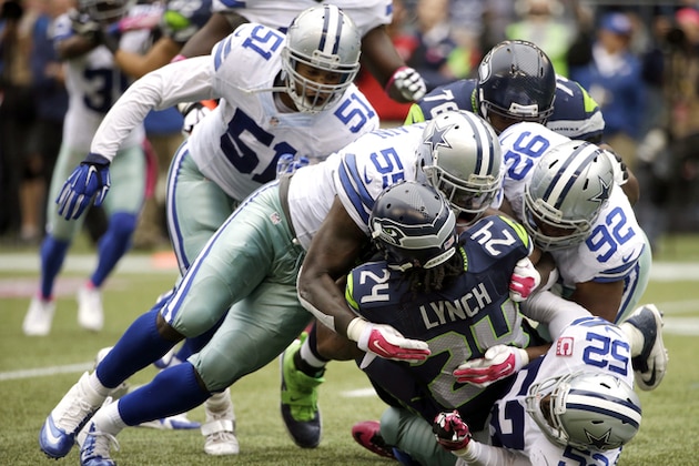FILE - In this Oct. 12, 2014, file photo, Seattle Seahawks running back Marshawn Lynch (24) is tackled by Dallas Cowboys' Rolando McClain (55), Jeremy Mincey (92), and Justin Durant (52) in the second half of an NFL football game, in Seattle. Mincey came to Dallas as the