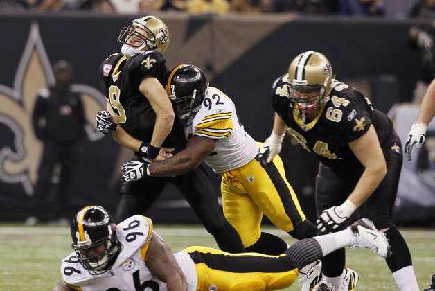 New Orleans Saints quarterback Drew Brees (9) is hit by Pittsburgh Steelers linebacker James Harrison (92) after releasing a pass during the first half of an NFL football game at the Louisiana Superdome in New Orleans, Sunday, Oct. 31, 2010. Also in on the play are Steelers defensive end Ziggy Hood (96) and Saints offensive tackle Zach Strief (64). (AP Photo/Patrick Semansky)