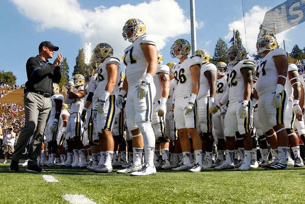 Oct 18, 2014; Berkeley, CA, USA; UCLA Bruins head coach Jim Mora Jr. encourages his team before the start of the game against the California Golden Bears at Memorial Stadium. Mandatory Credit: Cary Edmondson-USA TODAY Sports