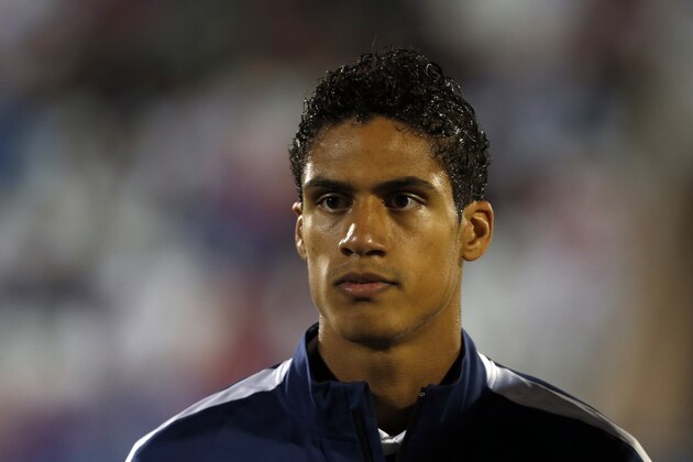 France's Raphael Varane stands during the playing of his country's national anthem before the start of their international friendly soccer match against Serbia, in Belgrade, Serbia, Sunday, Sept. 7, 2014. (AP Photo/Darko Vojinovic)