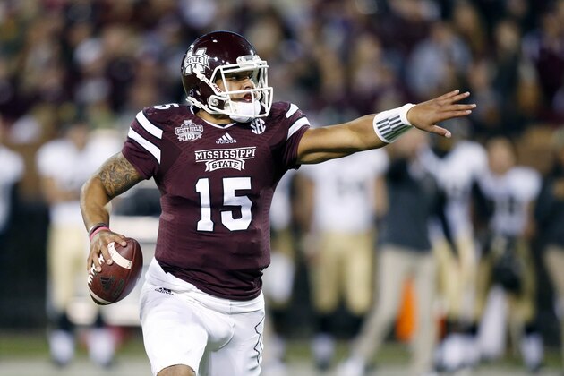 Mississippi State quarterback Dak Prescott (15) directs his blockers as he tries to find an open player in the first half of an NCAA college football game against Vanderbilt, Saturday, Nov. 22, 2014, in Starkville, Miss. (AP Photo/Rogelio V. Solis)