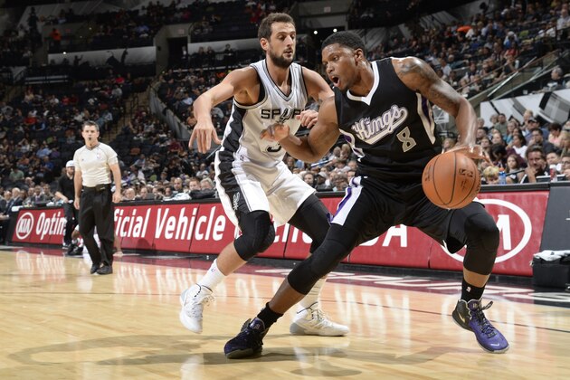 SAN ANTONIO, TX - OCTOBER 20:  Rudy Gay #8 of the Sacramento Kings handles the ball against Marco Belinelli #3 of the San Antonio Spurs at the AT&T Center on October 20, 2014 in San Antonio, Texas. NOTE TO USER: User expressly acknowledges and agrees that, by downloading and or using this photograph, user is consenting to the terms and conditions of the Getty Images License Agreement. Mandatory Copyright Notice: Copyright 2014 NBAE (Photos by D. Clarke Evans/NBAE via Getty Images)