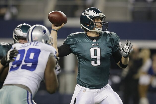 Philadelphia Eagles quarterback Nick Foles (9) passes under pressure from Dallas Cowboys defensive end George Selvie (99) during the first half of an NFL football game, Sunday, Dec. 29, 2013, in Arlington, Texas. (AP Photo/Tony Gutierrez)