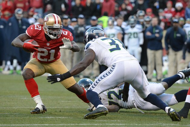 December 8, 2013; San Francisco, CA, USA; San Francisco 49ers running back Frank Gore (21) runs the football against Seattle Seahawks strong safety Kam Chancellor (31) during the fourth quarter at Candlestick Park. The 49ers defeated the Seahawks 19-17. Mandatory Credit: Kyle Terada-USA TODAY Sports