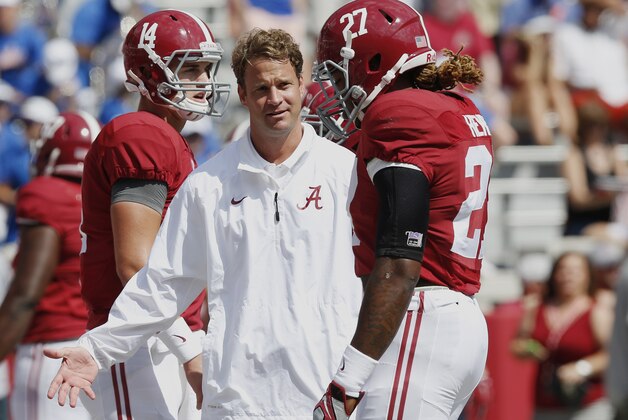 FILE - In this Sept. 20, 2014, file photo, Alabama offensive coordinator Lane Kiffin, center, talks to running back Derrick Henry (27) before an NCAA college football game against Florida in Tuscaloosa, Ala. Kiffin makes his return to Knoxville on Saturday, Oct. 25, 2014,  when the fourth-ranked Crimson Tide play the Volunteers. Kiffin coached at Tennessee for just one year before leaving for Southern California three weeks prior to National Signing Day. Although nearly five years have passed since Kiffin's hasty exit from Tennessee, Vols fans still haven't forgiven him. (AP Photo/Brynn Anderson, File)